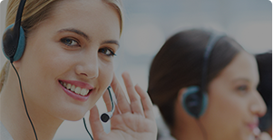 Two smiling customer service representatives wearing headsets