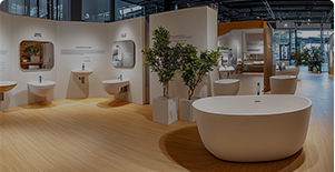 Modern bathroom display with a freestanding bathtub, sink, and decorative plants